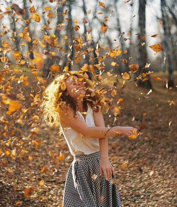 Woman feeling vibrant and energetic in a sunlit room.